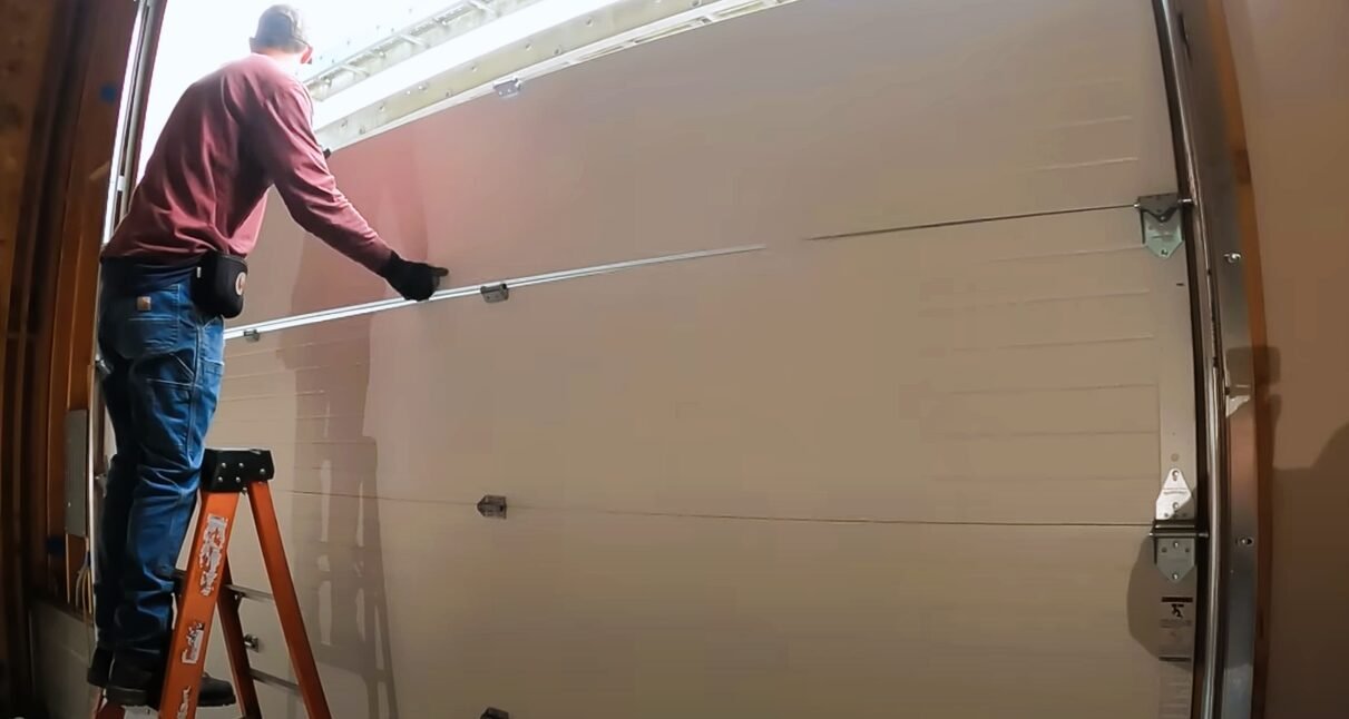 A technician performing garage door repair in Columbus, Ohio, showcasing a high-quality service provided by a trusted local garage door supplier.