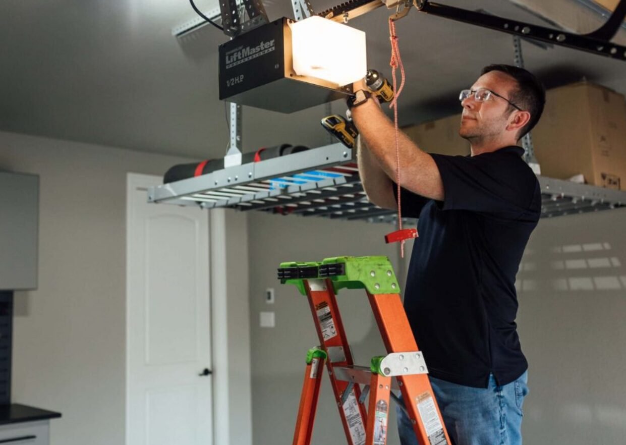 A technician from Garage Door Supplier in Columbus, Ohio, performing garage door opener repair on a residential unit, ensuring smooth and efficient operation.
