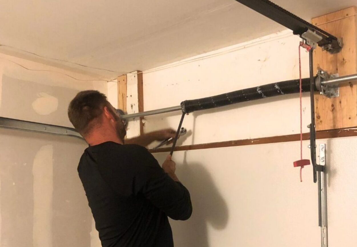 Professional garage door spring repair service in Columbus, Ohio displaying a technician adjusting a garage door spring for optimal performance.