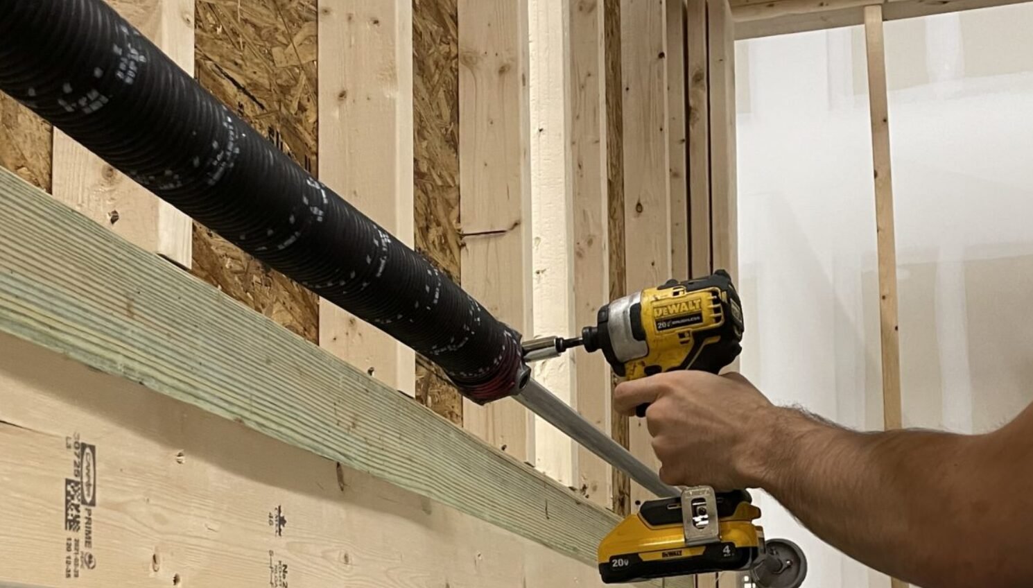 Close-up view of a technician performing garage door spring repair at a residential property in Columbus, Ohio.