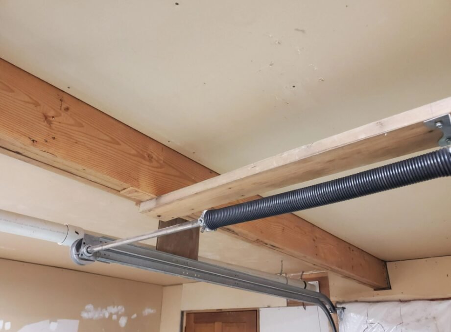 Close-up image of a technician performing garage door spring repair at a Columbus, Ohio garage door supplier, showcasing tools and expertise in service.